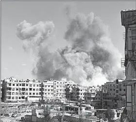  ?? AP ?? This photo, released Friday by the activist group Ghouta Media Center, shows smoke rising after Syrian government airstrikes hit Ghouta, a suburb of Damascus.