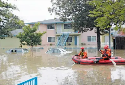  ?? "1 1)050 ?? Rescuers travel by boat through a flooded neighborho­od looking for stranded residents Tuesday, Feb. 21, 2017, in San Jose, Calif. Rescuers chest-deep in water steered boats carrying dozens of people, some with babies and pets, from a San Jose...