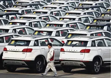  ?? — AP ?? Big plan: Haval SUVs parked outside the Great Wall Motors assembly plant in Baoding, China’s Hebei province. The company’s strategic goal is to become the world’s largest SUV maker.
