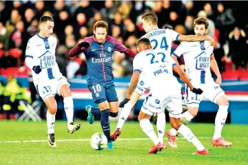  ?? — AFP photo ?? Paris Saint-Germain's Brazilian forward Neymar (C) vies with Troyes' players during the French L1 football match between Paris SaintGerma­in (PSG) and Troyes at the Parc des Princes stadium in Paris on November 29, 2017.