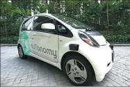  ?? YONG TECK LIM / AP ?? An autonomous vehicle is parked for its test drive in Singapore on Wednesday. The taxi service will start small, with six cars, growing to a dozen by the end of the year. The goal is to have a fully self-driving taxi fleet by 2018.