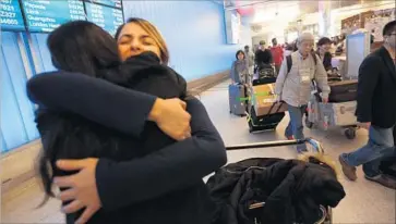  ?? Genaro Molina Los Angeles Times ?? SARA YARJANI, right, is welcomed by her sister, Sahar Muranovic, after she arrived at Los Angeles Internatio­nal Airport on Feb. 5. Yarjani had been detained and then deported under President Trump’s travel ban.