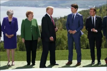  ?? EVAN VUCCI — THE ASSOCIATED PRESS ?? President Donald Trump arrives for the family photo during the G-7 Summit, Friday in Charlevoix, Canada. From left, British Prime Minister Theresa May, German Chancellor Angela Merkel, Trump, Canadian Prime Minister Justin Trudeau, and French President...