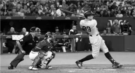  ?? VAUGHN RIDLEY/GETTY IMAGES ?? Aaron Judge drove a belt-high sinker on a full count from lefthander Tim Mayza over the left-field fence at Rogers Centre. The 117.4-m.p.h. drive took just 3.8 seconds to land 394 feet from the plate.