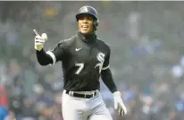  ?? CHARLES REX ARBOGAST/AP ?? Tim Anderson looks to his teammates in the dugout as he celebrates his home run against the Cubs, a home run that Cease not only predicted, but that he predicted that Anderson would hit it to the opposite field, which he did.