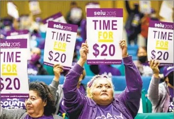  ?? Robert Gauthier Los Angeles Times ?? SERVICE WORKERS press for higher wages during a 2022 protest in downtown L.A. California has among the highest minimum wages in the country, but the state is also home to some of the priciest cities in the world.