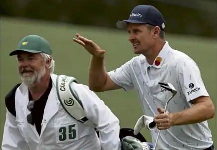  ?? Ap; BELOW, GETTY IMAGES ?? Justin rose and his caddie david Clark react to his second shot on the 18th hole during the first round of the Masters at augusta National Golf Club on Thursday in augusta, Ga. Below, Bryson dechambeau reacts to his putt on the 18th green.