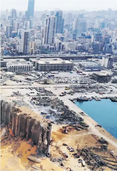  ??  ?? ► Vista aérea del puerto de Beirut, el silo de granos dañado y el cráter causado por la explosión registrada el martes.