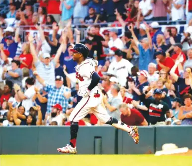  ?? AP FILE PHOTO/JOHN BAZEMORE ?? Atlanta Braves’ Ozzie Albies rounds first base after hitting a three-run home run during the third inning against the Philadelph­ia Phillies last season in Atlanta. Major League Baseball owners gave the go-ahead Monday to making a proposal to the players’ union that could lead to the season starting around Fourth of July weekend in ballparks without fans.