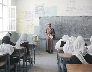 ?? CANADIAN ARMED FORCES/AKDN FILESS ?? A woman teaches in a government school for girls in the Eraq valley of Afghanista­n. Research consistent­ly shows that education levels among mothers is directly linked to 80 markers of family health, notes Terry Glavin.