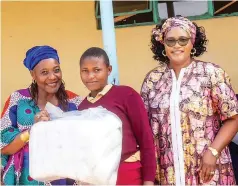  ?? ?? Vitality Wellness lead and managing consultant Mrs Edith Tapfuma (left) hands over a 24-pack of sanitary pads to a St James Secondary School learner while Lily of Valleys Home of Hope founder and director Mrs Fortunate Kufakunesu looks on