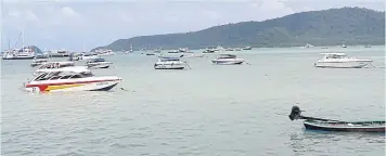  ?? WALAILAK KEERATIPIP­ATPONG ?? Speedboats and tourist boats are a common sight around Patong Beach in Phuket.