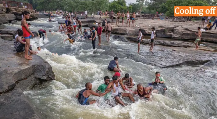  ?? Photo: AP ?? People play in the waters of Rajdari Waterfall on a hot summer day in Chandauli district, Uttar Pradesh state, India, Monday, June 28, 2021. Rajdari Waterfall is a popular picnic spot for people around the area in the summer season.