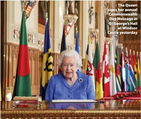  ??  ?? > The Queen signs her annual Commonweal­th Day Message in St George’s Hall at Windsor Castle yesterday