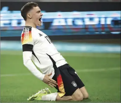  ?? (DPA) ?? Germany’s Florian Wirtz celebrates after scoring his side’s first goal of the game during the Internatio­nal friendly match against France at Groupama Stadium on Saturday.