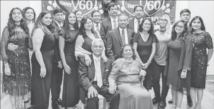  ?? ?? Dharamdeo and Angela Sawh (seated) with their children, in-laws and grandchild­ren on their 60th wedding anniversar­y in Dayton, Ohio