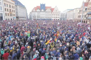  ?? SEBASTIAN WILLNOW/FOREIGN SUBSCRIBER, ASSOCIATED PRESS ?? Thousands gather to demonstrat­e against right-wing extremism, in the market square in Leipzig, Germany on Sunday. They come in the wake of a report that right-wing extremists recently met to discuss the deportatio­n of millions of immigrants, including some with German citizenshi­p.