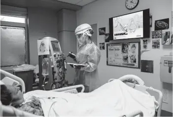  ?? ISADORA KOSOFSKY/THE NEW YORK TIMES ?? Masha Crawford, a nurse, tends to a patient on dialysis Feb. 13 in Los Angeles.