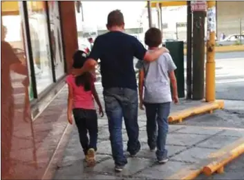  ??  ?? This July 24 photo courtesy of Guatemalan migrant Lucia shows her husband, Rene, with their 7-year-old daughter and 11-year-old son, as they walk in search of a place to sleep in Monterrey, Mexico. LUCIA VIA AP