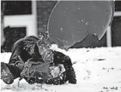  ?? ANDREW KRECH/NEWS & RECORD ?? Griffin Hussey takes a tumble while sledding Saturday in Greensboro, N.C. Parts of the South saw 10 inches of snow.