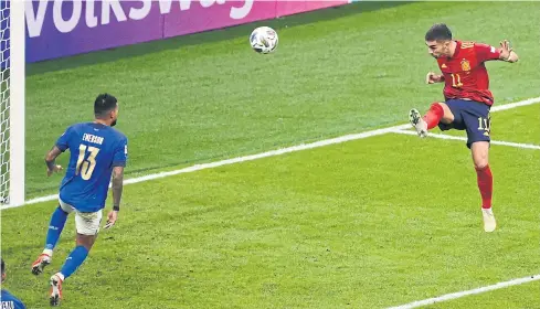  ?? REUTERS ?? Spain’s Ferran Torres, right, heads home their second goal against Italy at the San Siro in Milan.