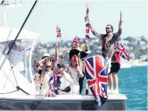  ?? PHOTOS: GETTY IMAGES ?? Brittania rules the waves . . . British fans show their support as Team UK notches a second upset win over Luna Rossa in round one, race 2.