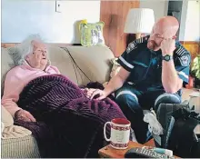  ?? NIAGARA EMS ?? Paramedic Darren Vanderlee, with the community response unit, holds the hand of 98-year-old Josephine Horner during a home visit.