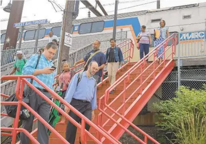  ?? KARL MERTON FERRON/BALTIMORE SUN ?? Commuters emerge Friday from a northbound MARC train at the West Baltimore stop. Passengers have complained about recent delays in service. “I’m 35 going on 70 because of this commute,” says passenger Michael Collins.