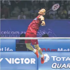  ??  ?? Malaysia’s Lee Chong Wei jumps for a smash in the men’s singles match.