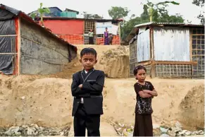  ?? — Reuters ?? Hoping for a better future: Rohingya refugee children standing outside Balukhali refugee camp near Cox’s Bazar, Bangladesh.
