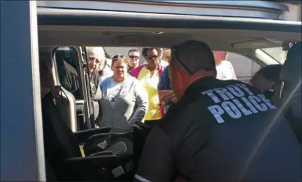  ?? KEITH WHITCOMB JR. — KWHITCOMB@DIGITALFIR­STMEDIA.COM ?? Troy Police teach employees of the Star and Strand Transporta­tion company how to properly install child safety seats.