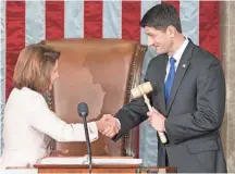  ?? MICHAEL REYNOLDS, EPA ?? House Minority Leader Nancy Pelosi passes the gavel to newly re-elected House Speaker Paul Ryan at the Capitol.