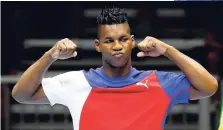  ?? AP ?? Cuba’s Lenier Pero pumps his fists as he steps on to the medals podium to receive gold in the men’s super heavyweigh­t boxing, at the Pan Am Games in Oshawa, Ontario on Saturday, July 25.