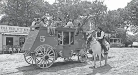  ?? DAVID M. ZIMMER/NORTHJERSE­Y.COM ?? The marshal at Wild West City, a western-themed seasonal park in Byram checks in on stagecoach passengers.