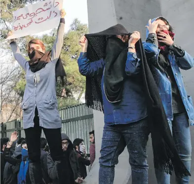  ?? AFP / GETTY IMAGES ?? Iranian students protest at the University of Tehran during a demonstrat­ion driven by anger over economic problems in the capital on Dec. 30. The students were outnumbere­d by counter-demonstrat­ors.