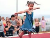  ?? Photo: Andy Jackson/
Fairfaxnz ?? Give it a whirl: A 3-year-old takes the loudest cheer of the day in winning the Junior Miss Taranaki competitio­n at last year’s New Year’s Day beach carnival at Oakura Beach.