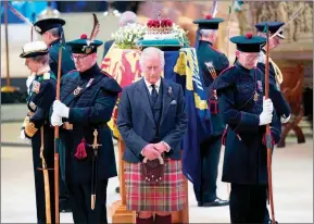  ?? The Associated Press ?? Britain’s King Charles III, centre, and other members of the royal family hold a vigil at the coffin of Queen Elizabeth II at St. Giles’ Cathedral, Monday, in Edinburgh, Scotland.