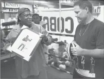  ??  ?? RECOGNITIO­N FOR his devotion to boxing has come in many forms to John Scully, from receiving a gift from Steve Ike recently at the Charter Oak Academy, to being honored with the prestigiou­s Bert Sugar Award.