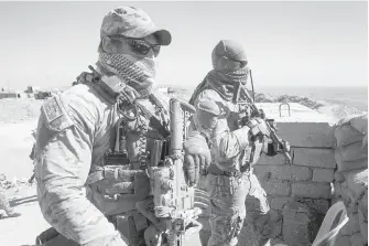  ?? PHOTOS BY RYAN REMIORZ, THE CANADIAN PRESS ?? Left: Canadian special forces personnel look over a Peshmerga observatio­n post in northern Iraq on Monday. Right: Smoke rises after an air strike near the city of Mosul in northern Iraq.