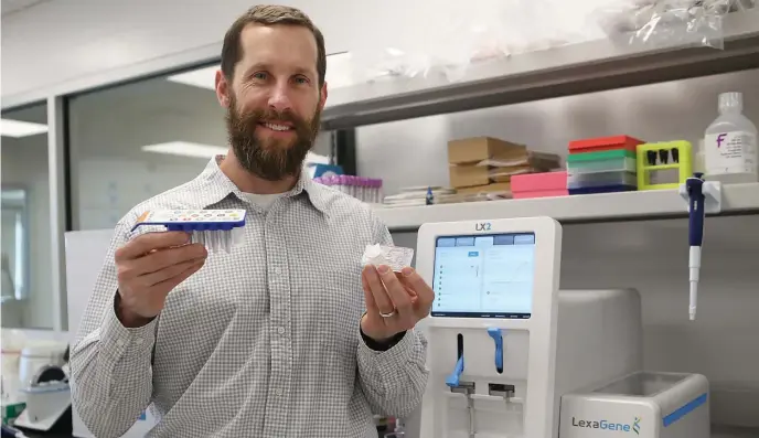  ?? NANCY LANE PHOTOS / HERALD STAFF ?? SIMPLE SOLUTION: Jack Regan, CEO and founder of LexaGene, shows off his pathogen detection system on Monday in Beverly,