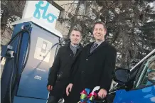  ?? GAVIN YOUNG ?? Louis Tremblay, president and CEO of FLO, left, and Wayne Strensby, managing director, electricit­y for Atco, show off one of the new fast-charging stations for e-vehicles in Calgary on Tuesday.