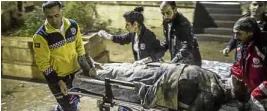  ?? AP ?? TURKISH OLIVE BRANCH Paramedics carry a wounded person from the rubble of a mosque in Kilis, Turkey, which was hit by rockets from Syria during evening prayers.—