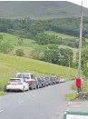  ??  ?? A line of parked cars near Ben Lawers and the remnants of a bonfire at Loch Rannoch.