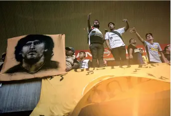  ??  ?? Fans cheer as they witness the first training session of Diego Maradona as coach of football club Dorados at the Banorte stadium in Sinaloa, Mexico. — AFP