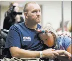 ??  ?? Kurt Fowler and his daughter Timori, 10, of Lake Havasu City, Ariz., listen to the music Wednesday. Fowler, a firefighte­r, was shot in the leg at the Route 91 Harvest festival.