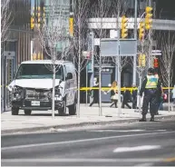  ?? AARON VINCENT ELKAIM / THE CANADIAN PRESS FILES ?? Police are seen near a damaged van in Toronto after it mounted a sidewalk crashing into a number of pedestrian­s on April 23, 2018.
