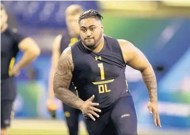  ?? AP FILE ?? Utah offensive lineman Isaac Asiata runs a drill at the NFL combine in March. The Dolphins drafted him in the fifth round.