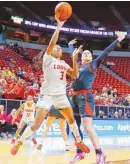  ?? MIKE SANDOVAL / FOR THE JOURNAL ?? UNM’s Nyah Wilson, left, shoots in front of San Diego State’s Abby Prohaska during a Mountain West Conference Tournament quarterfin­al in Las Vegas. Wilson is entering the NCAA transfer portal.