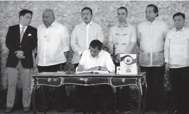  ??  ?? PRESIDENT Rodrigo Duterte signs into law the General Appropriat­ions Act (GAA) of 2020 during a ceremony at the Malacañan Palace. The P4.1-trillion national budget for 2020 is 9 percent higher than last year’s PHP3.76 trillion budget. Presidenti­al Photo