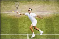  ?? Matthias Hangst / Getty Images ?? Roger Federer of Switzerlan­d plays a forehand in his quarterfin­al contest against Japan’s Kei Nishikori at Wimbledon on Wednesday.